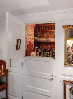 an open door leading to a bar with liquor bottles on the shelves in front of it