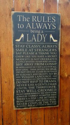 the rules to always being a lady sign on a wooden fence