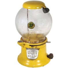 an old fashioned gummy machine with a glass ball on it's front and bottom