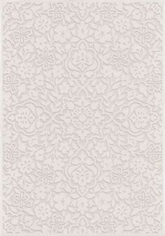 a white wallpaper with an intricate design on the front and back side of it