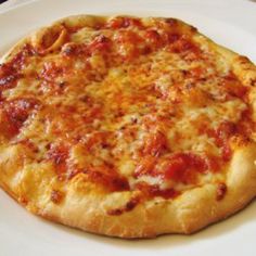 a pizza sitting on top of a white plate