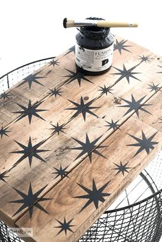 a wooden table with black stars painted on it