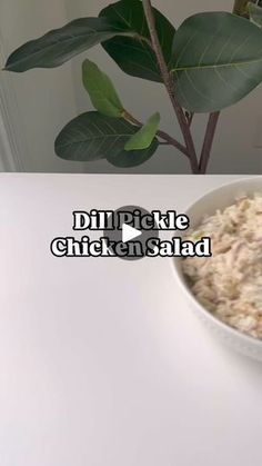 a bowl of food sitting on top of a table next to a potted plant