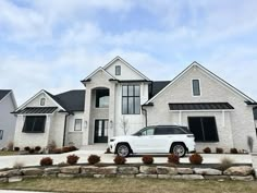 a white car parked in front of a house