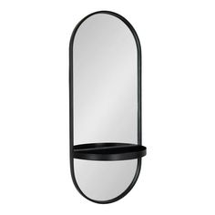 an oval mirror hanging on the wall with a shelf underneath it and a black shelf below