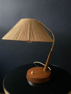 a wooden lamp on top of a black table