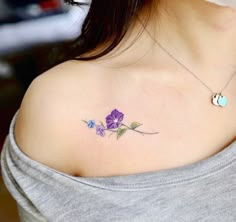 a woman with a purple flower tattoo on her shoulder