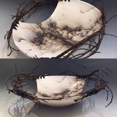 two white bowls with branches in them