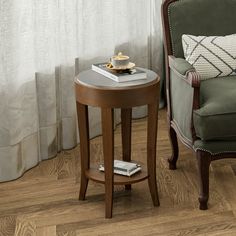 a small table with a book on it next to a chair