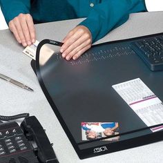 a woman sitting at a desk with a laptop and calculator