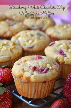 strawberry muffins on a cooling rack with strawberries