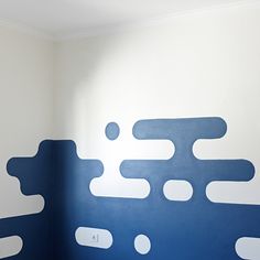 a room with blue and white paint on the walls, painted like an abstract pattern