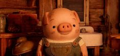 an animated pig with overalls standing in a kitchen