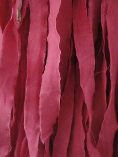 closeup of pink fabric hanging from the ceiling