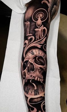 a man with a clock and skull tattoo on his arm