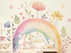 a child's room with a rainbow painted on the wall next to a desk