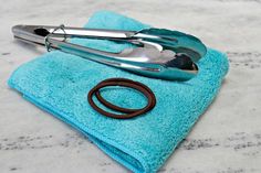 a pair of scissors sitting on top of a blue towel