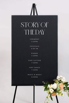 a sign that has flowers on it and the words story of the day written in black