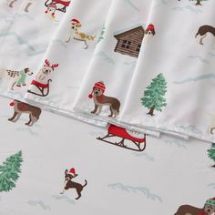 the bedding has dogs and sleighs on it