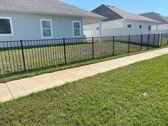 a black fence in front of a house