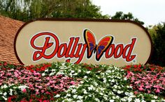 the sign for dollywood is surrounded by flowers