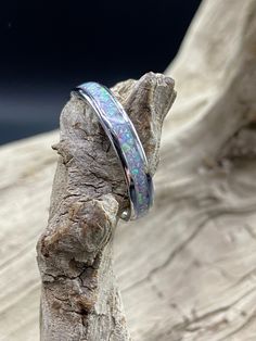 This beautiful handcrafted Stainless Steel comfort band is a real conversation starter! It features a Unicorn Purple Opal inlay in the center of the ring. The crushed Opal is placed by hand, incased in resin, and then finished and polished to a brilliant shine. Each ring I make is truly unique and no two are ever the same. These rings are made to order and are available in several sizes. Use the drop down boxes to choose your ring size and width. Please allow 3-5 days for me to complete your rin Unicorn Purple, Opal Band Ring, Opal Wedding Band, Purple Opal, Fashion Rings Silver, Opal Band, Opal Wedding Rings, Womens Ring, Fire Opal Ring