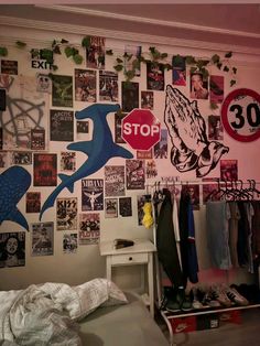 a bedroom with posters and pictures on the wall