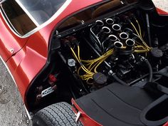 the engine compartment of a red sports car