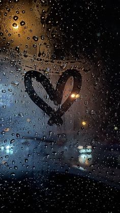 rain drops on the windshield of a car at night