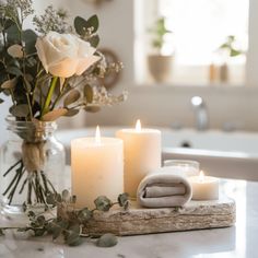 candles and towels on a table in a bathroom