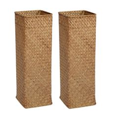 two tall vases made out of straw are sitting side by side on a white background