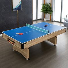 a ping pong table in the middle of a living room