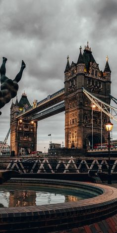 the tower bridge is lit up at night