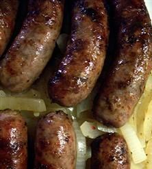 several sausages and onions on a plate