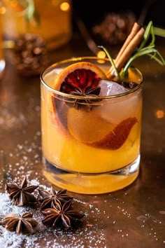 an orange drink with cinnamon and star anise garnish