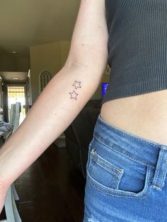 a woman's arm with three stars on it and the other side of her arm