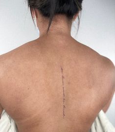 the back of a woman's neck with writing on it