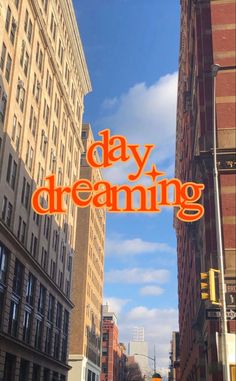 an orange sign that says day dreaming on the side of a building