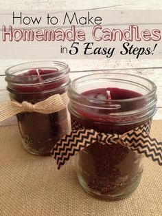 two jars filled with homemade candles sitting on top of a burlick covered table