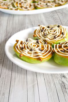 two white plates topped with green apples covered in frosting