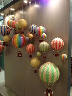 a group of colorful hot air balloons hanging from the ceiling