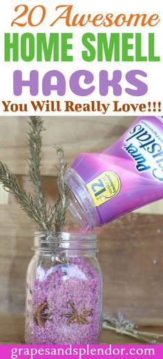 a jar filled with pink sand next to a sprig of rosemary and lavender