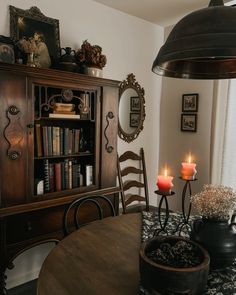 a dining room table with two candles on it