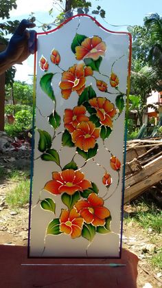 a glass panel with flowers painted on it