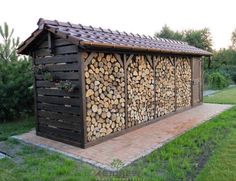 a building made out of logs sitting in the grass