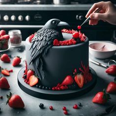 a person is decorating a cake with strawberries