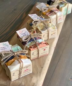 several soap bars tied with twine on a wooden board, sitting next to each other