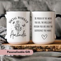 two personalized coffee mugs sitting on top of a wooden table next to a blanket