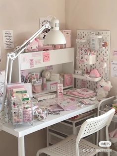 a craft room with lots of cards on the wall and desks in front of it