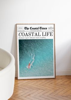 the coastal times magazine cover is displayed next to a white chair and wall with wood flooring